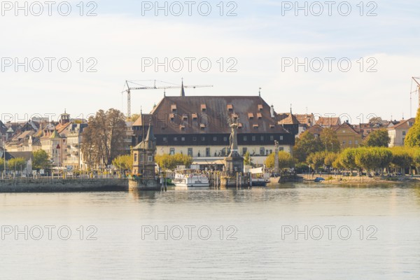 Historic riverside building with autumnal trees and peaceful atmosphere, Constance, Lake Constance,
