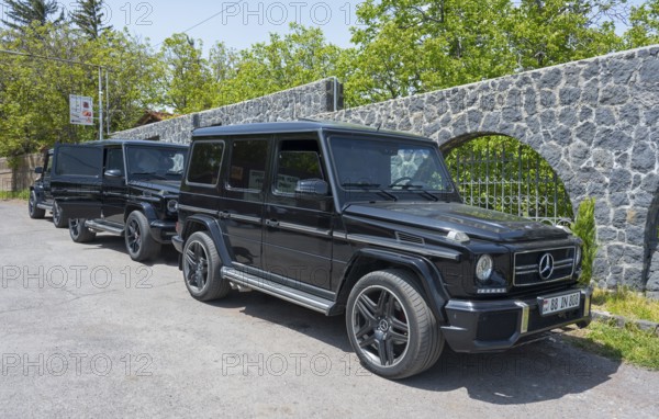 Two black Mercedes off-road vehicles parked next to each other in a car park, Mercedes-Benz