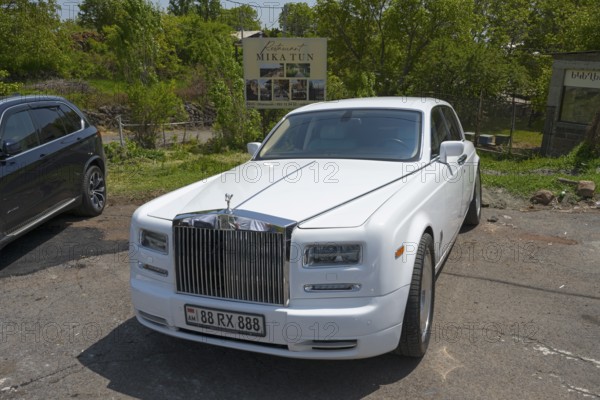 A white Rolls-Royce in a car park under trees on a sunny day, Rolls-Royce Phantom VII, Aragazotn