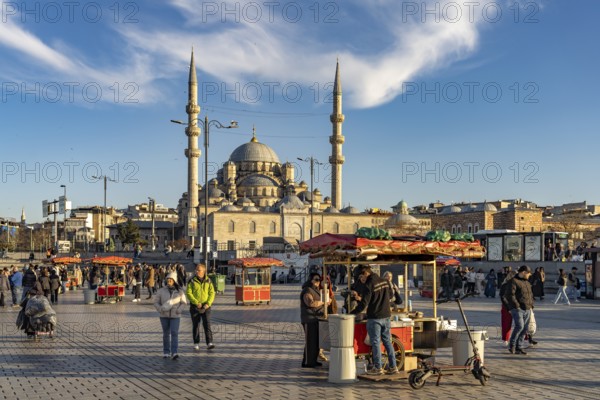 Stand with corn and chestnuts on Eminönü Square Eminönü Meydani and the New Mosque Yeni Cami in