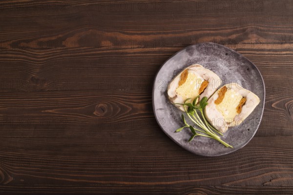 Chicken, egg and dried apricot meatloaf, microgreen on brown wooden. Diet, healthy eating. top