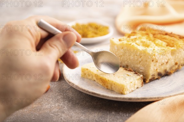 ?ottage cheese ?asserole, Curd cake, with dried apricots and raisins with hand on brown concrete
