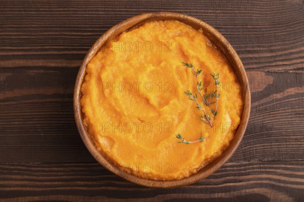 Sweet potato porridge in wooden bowl on wooden background. Diet, healthy eating concept. top view,