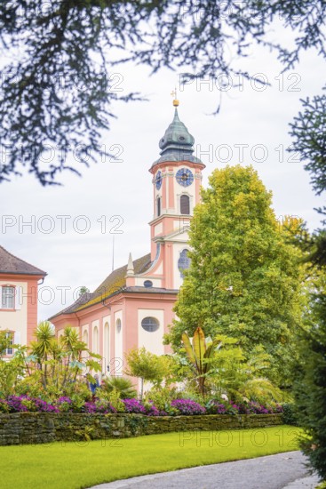 Historic church with beautiful garden in the foreground, Mainau flower island, Lake Constance,