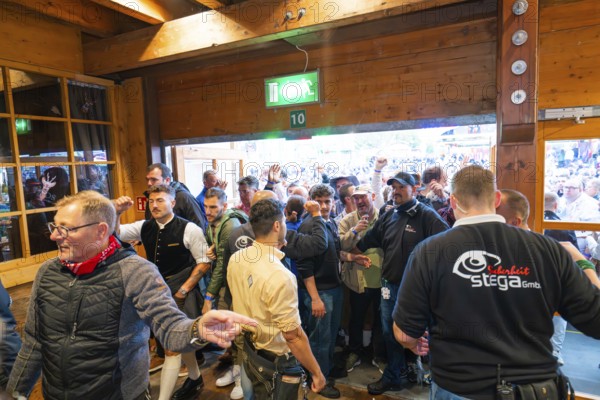 Crowd of people trying to get into the marquee, lively atmosphere, Cannstatter Wasen folk festival,