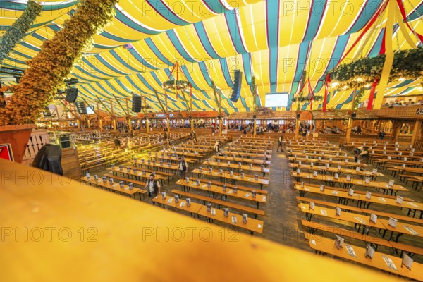Large marquee with colourful stripes and traditional interior design, Cannstatter Wasen folk