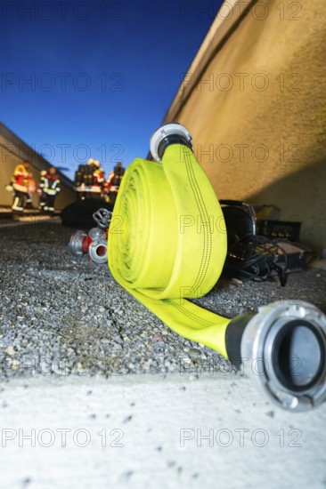 Roll-wound fire hose on the ground at night, fire drill in the new construction tunnel of the