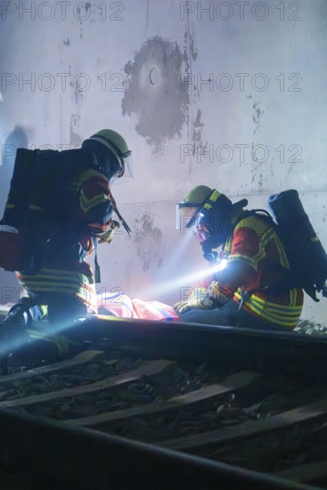 Firefighters provide first aid on tracks in a tunnel, firefighting exercise in the new tunnel of