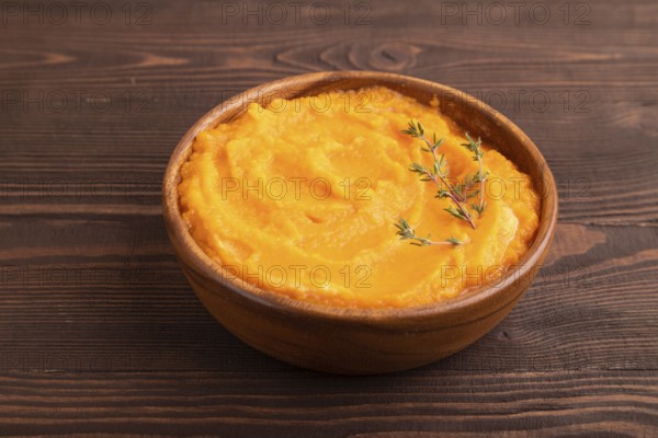 Sweet potato porridge in wooden bowl on wooden background. Diet, healthy eating concept. side view,