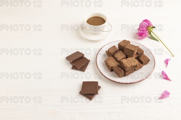 Chocolate marshmallow with cup of coffee on white wooden background. side view, copy space