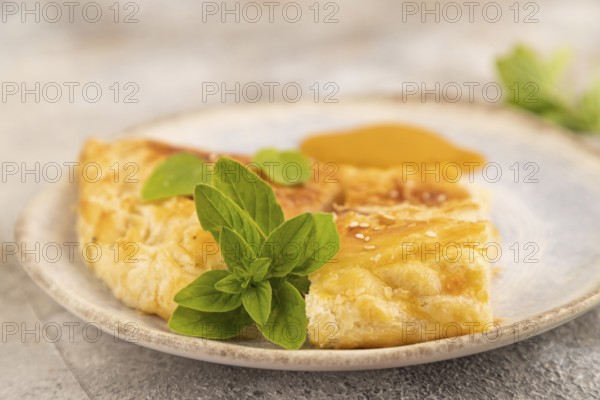 Fried homemade Khachapuri cake with cheese and meat, fried in pan. Traditional Georgian cuisine on