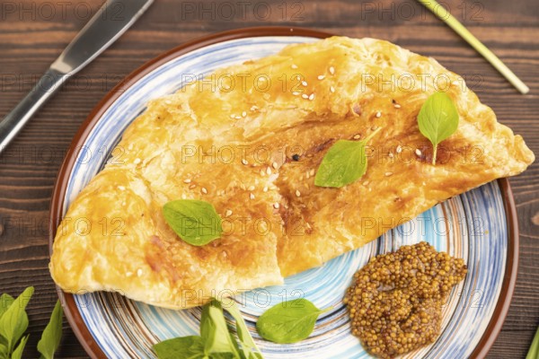 Fried homemade Khachapuri cake with cheese and meat, fried in pan. Traditional Georgian cuisine on