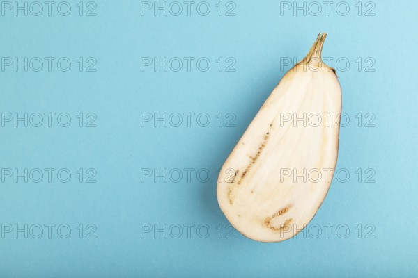 Purple Cutted eggplant on blue pastel background. Top view, flat lay, copy space. Tropical, healthy