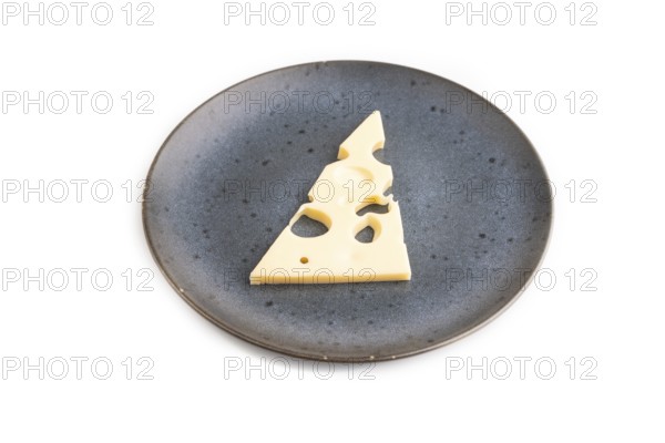 Piece of cheese with holes on blue plate isolated on white background, side view, copy space,