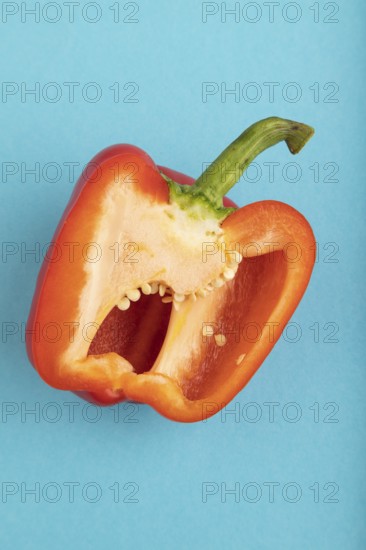 Red Cutted pepper on blue pastel background. Top view, flat lay, copy space. Tropical, healthy