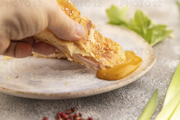 Fried homemade Khachapuri cake with hand with cheese and meat, fried in pan. Traditional Georgian