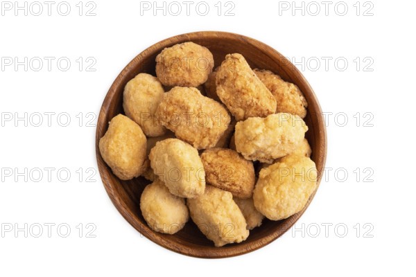 Fried crispy Chicken Nuggets in brown wooden bowl isolated on white background. top view, flat lay,