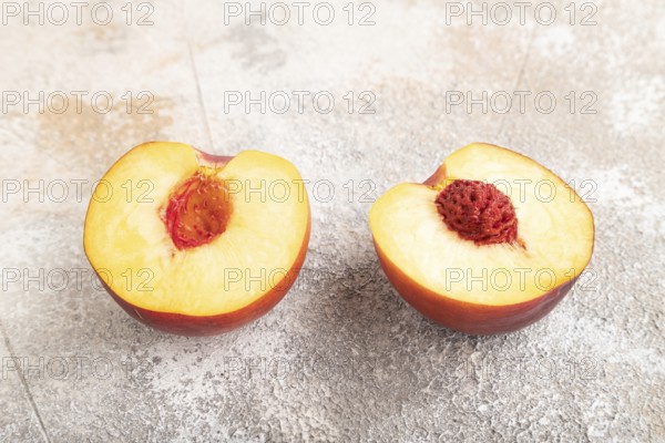 Peach Cut in half on brown concrete background. Side view, close up. healthy food, vegetable,