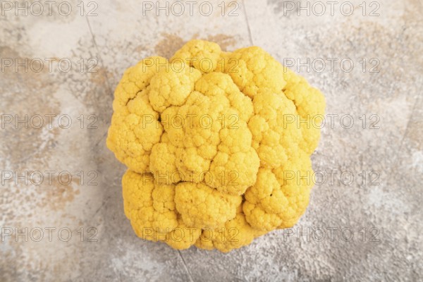 Yellow Cauliflower on brown concrete background. Top view, close up, flat lay. healthy food,