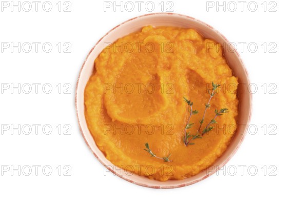 Sweet potato porridge in ceramic bowl isolated on white background. Diet, healthy eating concept.
