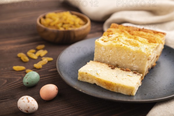 ?ottage cheese ?asserole, Curd cake, with dried apricots and raisins on brown wooden background and