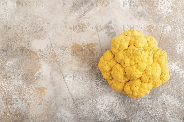 Yellow Cauliflower on brown concrete background. Top view, copy space, flat lay. healthy food,