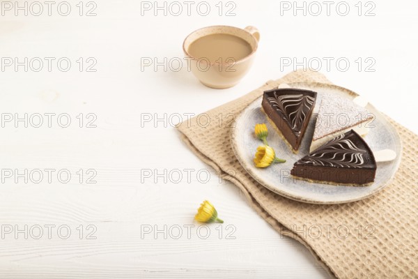 Chocolate and Vanilla Cake pops Marshmallow with cup of coffee on white wooden background and beige