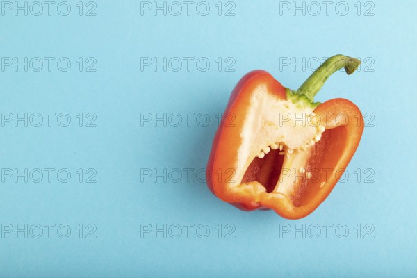 Red Cutted pepper on blue pastel background. Top view, flat lay, copy space. Tropical, healthy