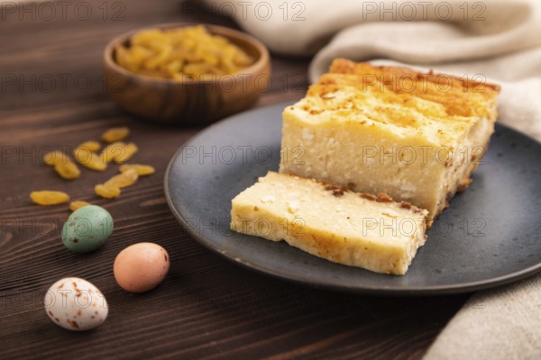 ?ottage cheese ?asserole, Curd cake, with dried apricots and raisins on brown wooden background and