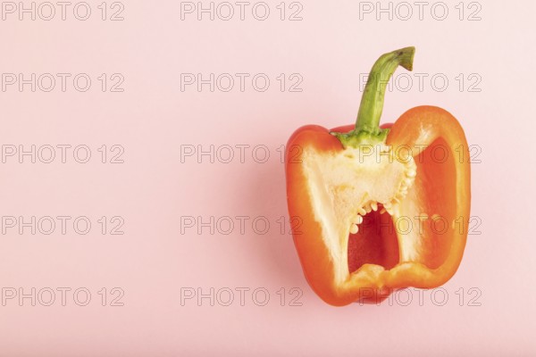 Red Cutted pepper on pink pastel background. Top view, flat lay, copy space. Tropical, healthy