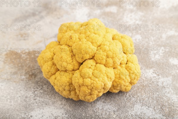 Yellow Cauliflower on brown concrete background. Side view, close up. healthy food, vegetable,