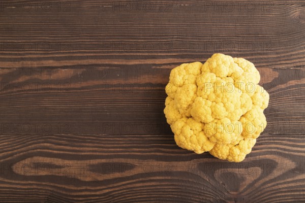 Yellow Cauliflower on brown wooden background. Top view, copy space, flat lay. healthy food,