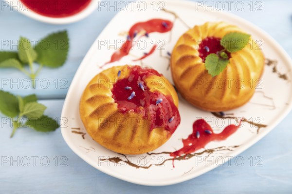 Semolina cheesecake with strawberry jam, lavender, cup of coffee on blue wooden background. side