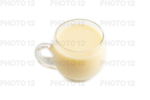Organic non dairy banana and soy milk in glass isolated on white background. Vegan healthy food