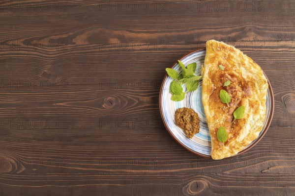 Fried homemade Khachapuri cake with cheese and meat, fried in pan. Traditional Georgian cuisine on