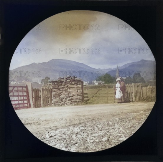 Woman Victorian or Edwardian tourist with background of Ambleside, Lake District, Cumbria, England,