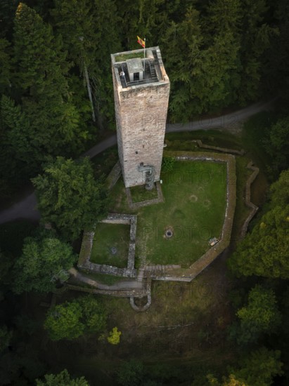A tower and surrounding ruins hide in the middle of dense forests, seen from above, Mandelberg