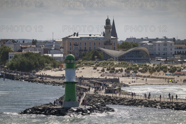 Green-white lighthouse, pier light Westmole, hotels in the background, Warnemünde, Rostock,