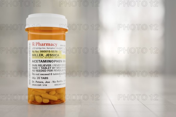 Acetaminophen prescription medicine bottle resting on A bathroom countertop. the label is