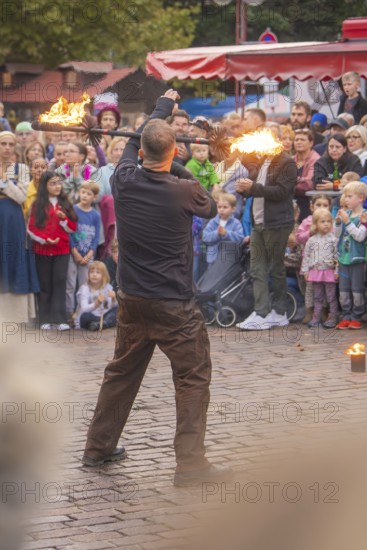 A juggler presents fiery arts in front of an astonished audience, Feuernacht, Sindelfingen, Germany