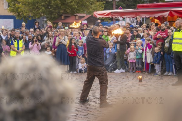 A fire juggler fascinates the audience with his art in a lively setting, Feuernacht, Sindelfingen,