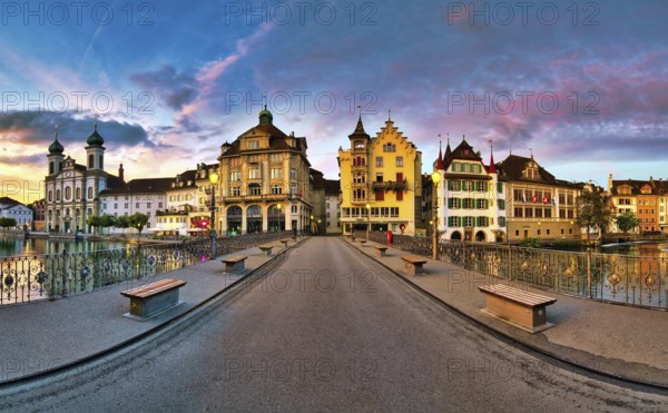 View of Lucerne's old town with Jesuit church from the Reuss bridge at dawn, Canton of Lucerne,