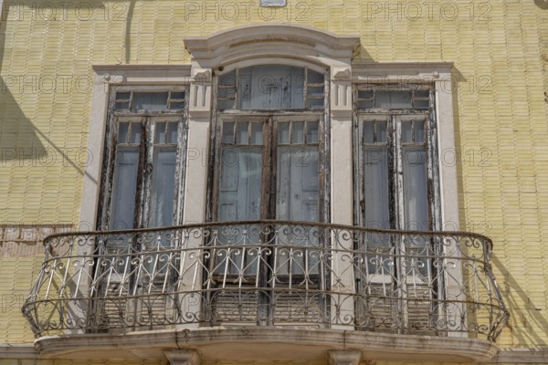 Facade of buildings decorated with tiles, azulejos, coloured tiles on facades, in Tavira, old town,