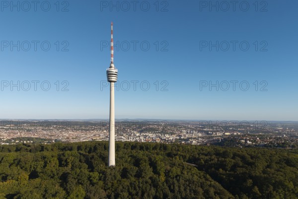 Television tower rises above a wooded area against an urban backdrop, Stuttgart, Baden-Württemberg,