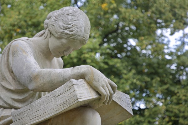 Seated white female figure reading a thick book as a symbol of science, allegory, knowledge,