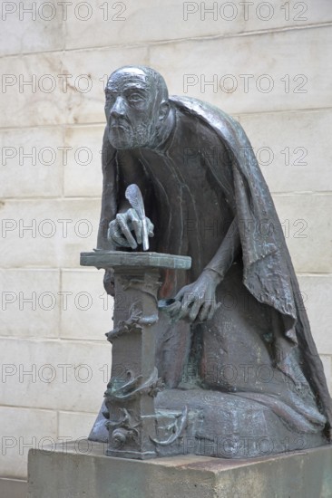 Albertus Magnus by Heinrich Apel 1985, medieval scholar and bishop writing with quill, view, bronze