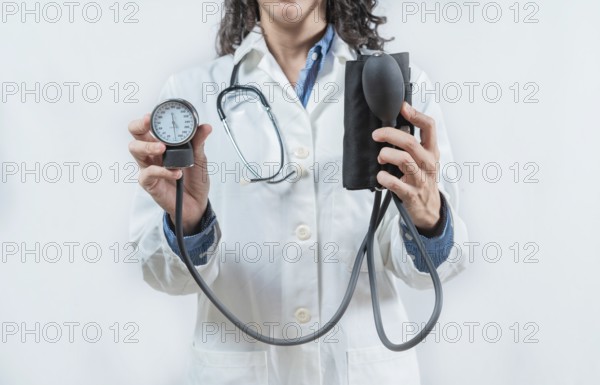 Doctor hands showing blood pressure monitor isolated. Close up of Doctor showing tensiometer
