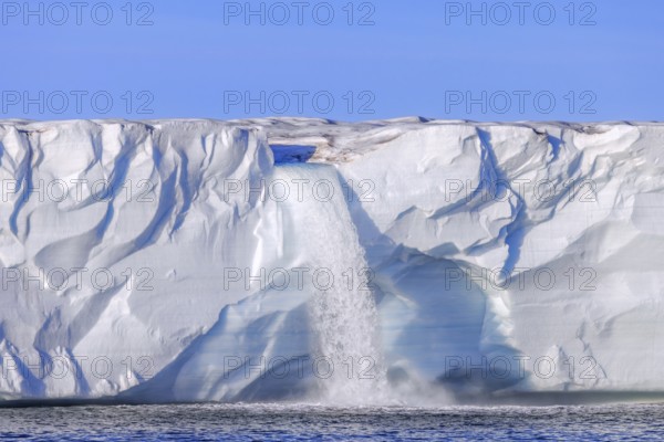 Waterfall at edge of the Brasvellbreen glacier from the ice cap Austfonna debouching into the