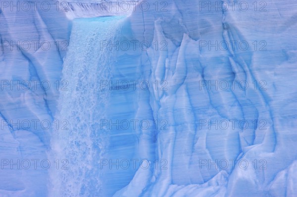 Waterfall at edge of the Brasvellbreen glacier from the ice cap Austfonna pouring into the Barents