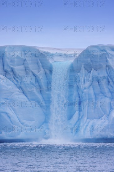 Waterfall at edge of the Brasvellbreen glacier from the ice cap Austfonna debouching into the